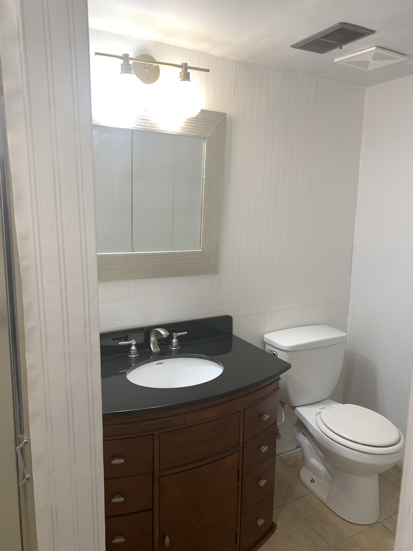1210 Devonshire Drive Joliet, IL 60435 - Photo 24 of 35 a bathroom with a sink and a toilet
