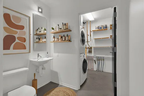 a bathroom with a sink toilet and a mirror