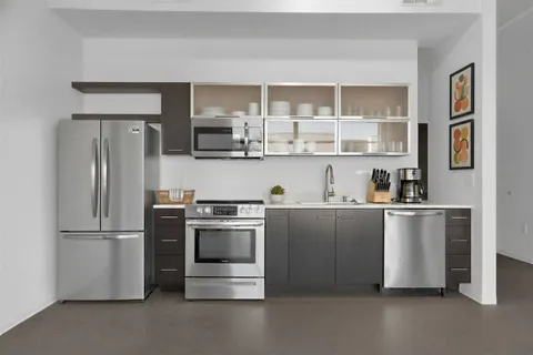 a kitchen with stainless steel appliances a refrigerator and a stove top oven