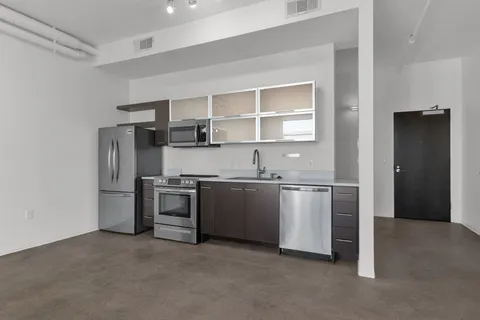 a view of a kitchen with a stove cabinets and a refrigerator