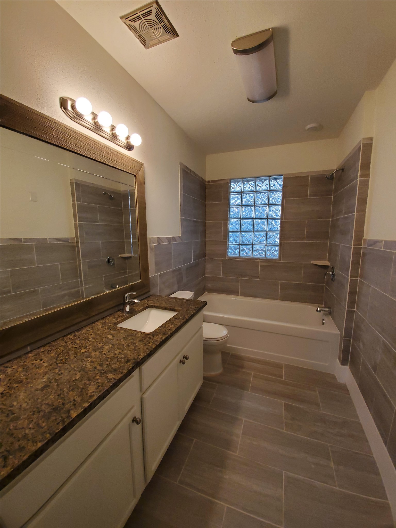 4113 Speedway Austin, TX 78751 - Photo 15 of 31 Tiled walls and a granite-topped vanity define this full bathroom.