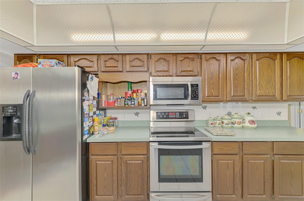 1137 Ponderosa Road Venice, FL 34293 - Photo 19 of 48 a kitchen with stainless steel appliances cabinets and a window