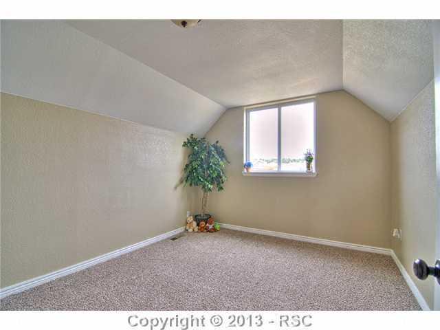10865 Falling Star Road Fountain, CO 80817 - Photo 14 of 23 Upstairs Bedroom w/ new carpet & warm custom paint.