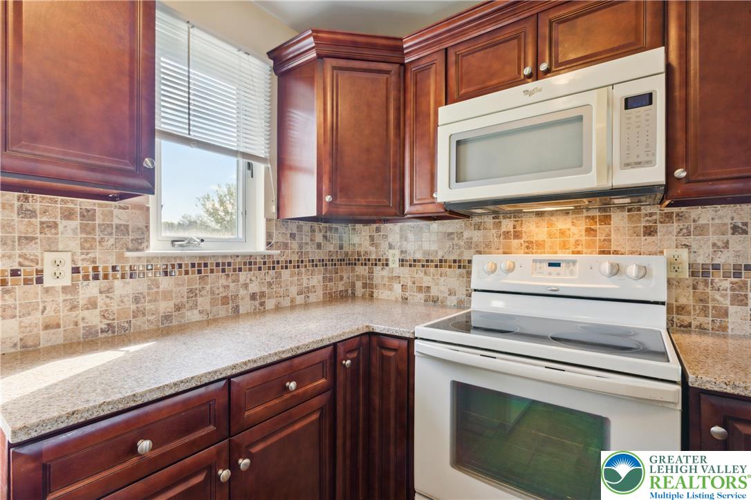 110 Drift Court, Unit B Bethlehem, PA 18020 - Photo 15 of 25 a kitchen with stainless steel appliances granite countertop a sink a stove and cabinets
