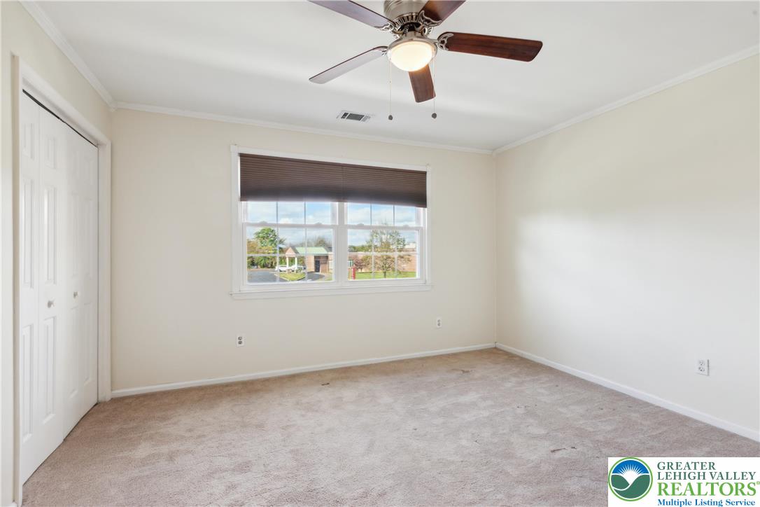 110 Drift Court, Unit B Bethlehem, PA 18020 - Photo 18 of 25 an empty room with a window and a ceiling fan