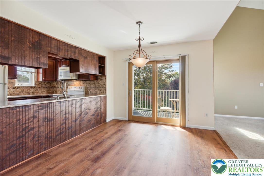 110 Drift Court, Unit B Bethlehem, PA 18020 - Photo 10 of 25 a view of a kitchen with wooden floor and stainless steel appliances