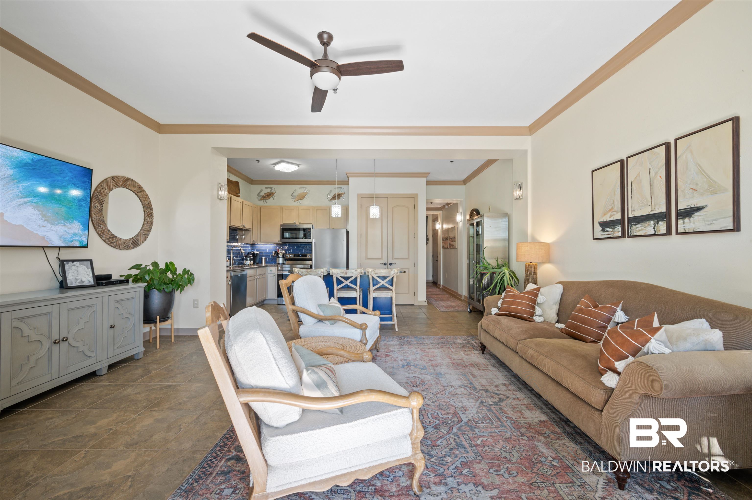 1430 Regency Road, Unit B202 Gulf Shores, AL 36542 - Photo 19 of 33 Living area with a ceiling fan, crown molding, and baseboards