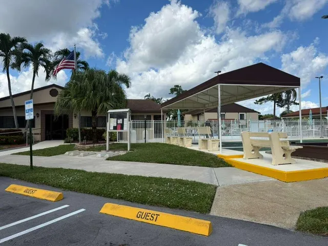 a view of a house with swimming pool and sitting area