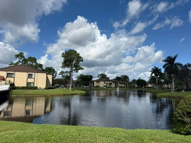 a view of a lake with houses in the background