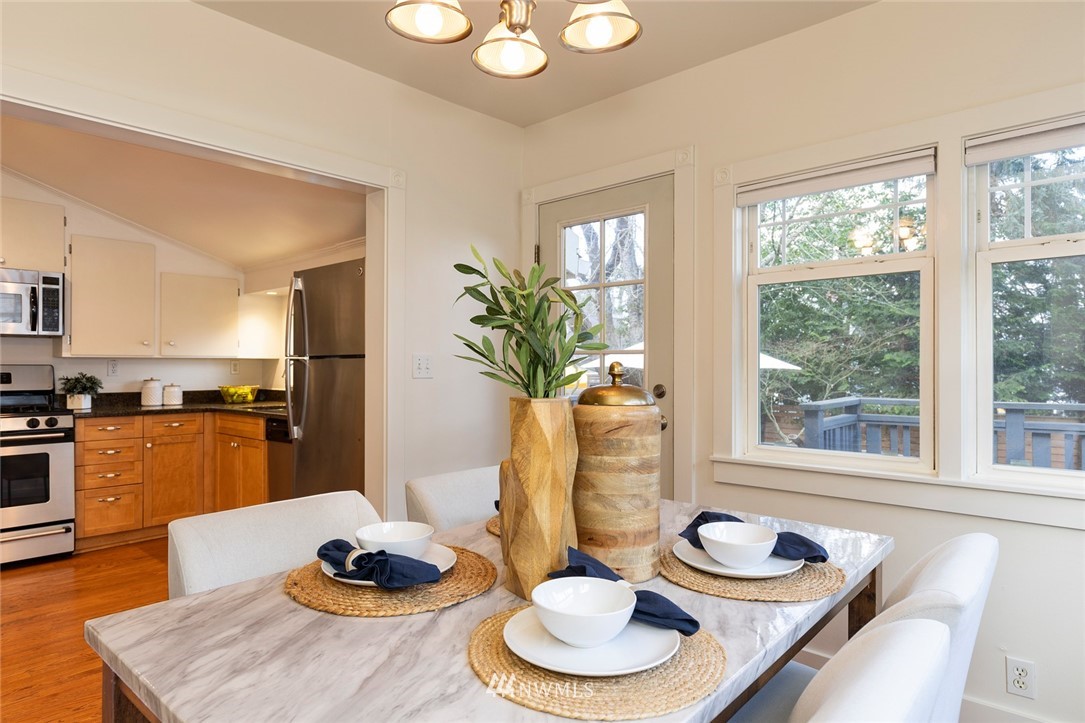 708 North 63rd Street Seattle, WA 98103 - Photo 11 of 24 a dining room with furniture and a wooden floor