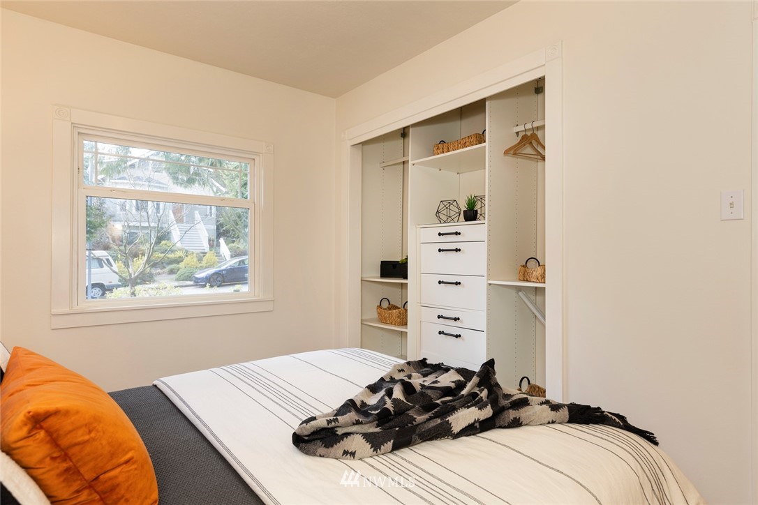 708 North 63rd Street Seattle, WA 98103 - Photo 14 of 24 a bed room with a bed and a window