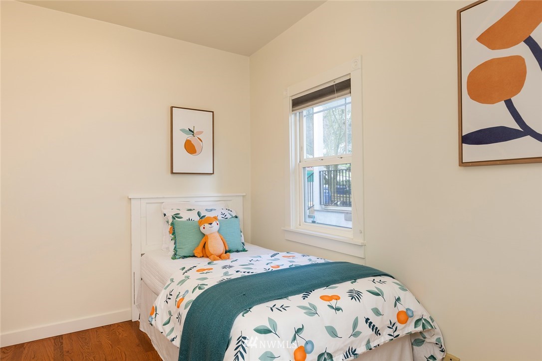708 North 63rd Street Seattle, WA 98103 - Photo 16 of 24 a bedroom with a bed and painting on the wall
