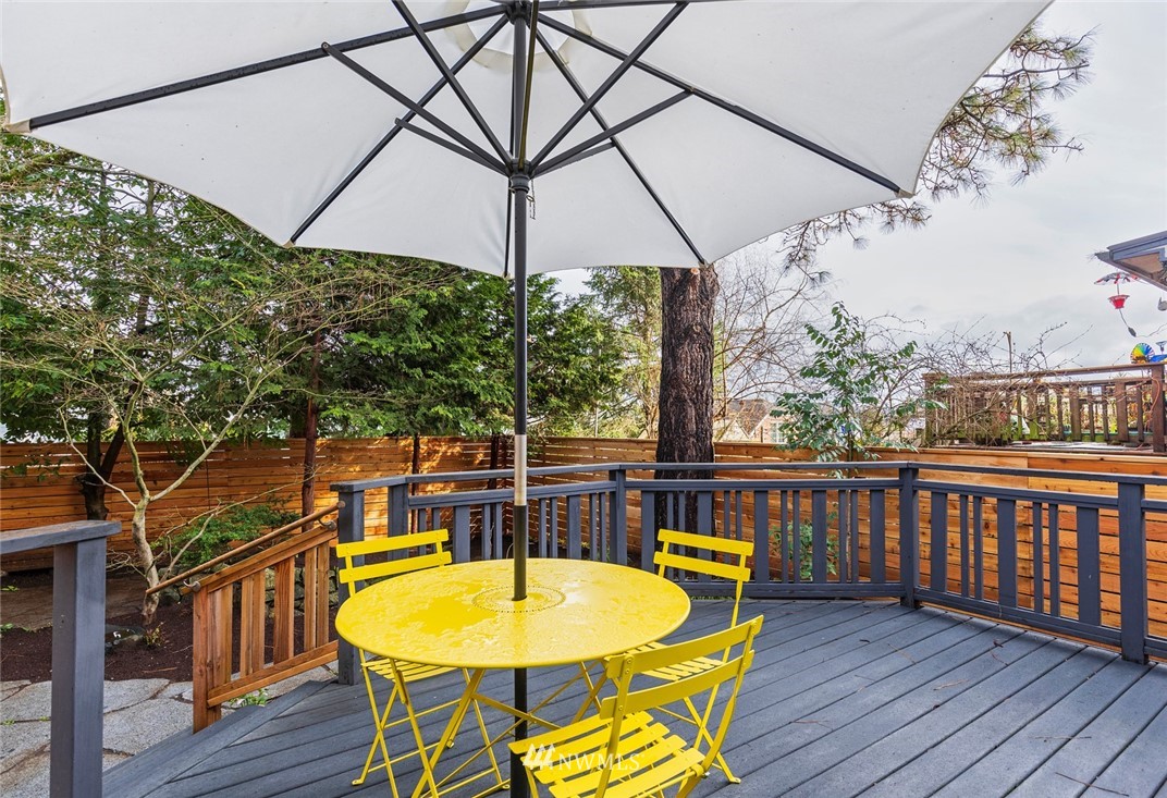 708 North 63rd Street Seattle, WA 98103 - Photo 23 of 24 a view of a swimming pool with a table and chairs under an umbrella