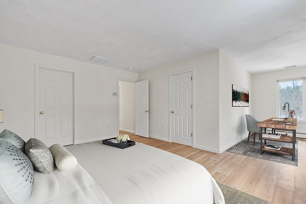 11 Longley Road, Unit I1 Shirley, MA 01464 - Photo 13 of 28 a bedroom with a bed and a chair