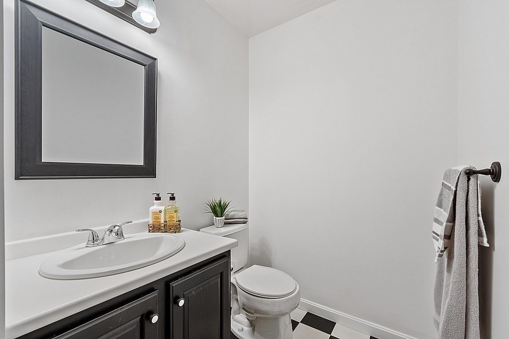 11 Longley Road, Unit I1 Shirley, MA 01464 - Photo 18 of 28 a bathroom with a granite countertop toilet sink and mirror