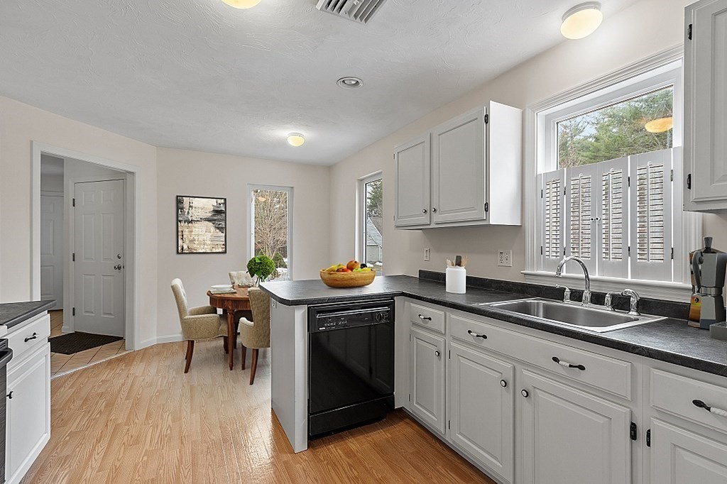11 Longley Road, Unit I1 Shirley, MA 01464 - Photo 6 of 28 a kitchen with granite countertop a sink a counter space appliances and cabinets
