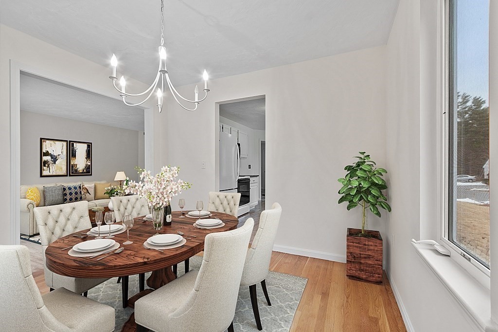 11 Longley Road, Unit I1 Shirley, MA 01464 - Photo 8 of 28 a view of a dining room with furniture and wooden floor