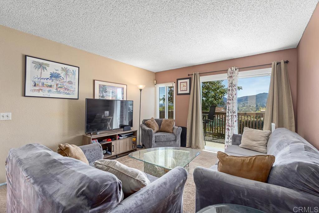 866 South Rancho Santa Fe Road, Unit C San Marcos, CA 92078 - Photo 3 of 14 a living room with furniture and a flat screen tv