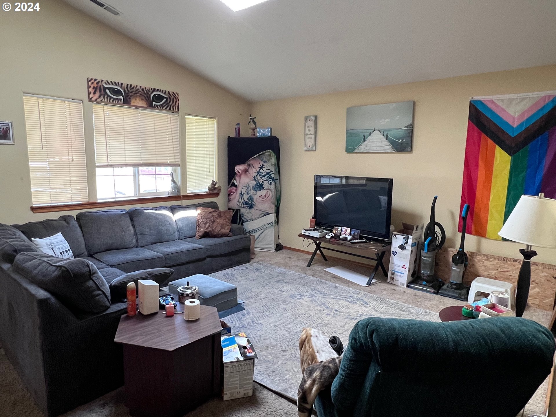 597 Nicholas Drive Springfield, OR 97477 - Photo 3 of 22 a living room with furniture a flat screen tv and a window