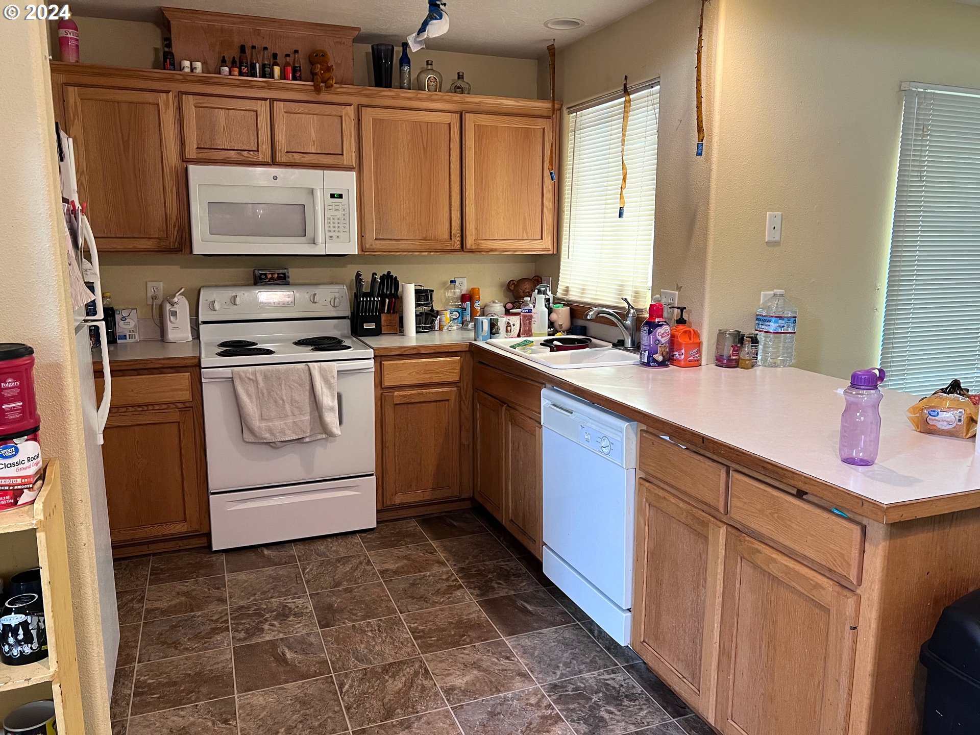 597 Nicholas Drive Springfield, OR 97477 - Photo 6 of 22 a kitchen with stainless steel appliances granite countertop a sink stove and cabinets
