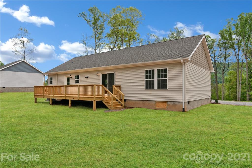 340 Ridge View Drive, Unit 6 Clyde, NC 28721 - Photo 22 of 22 a view of a house with a yard and sitting area