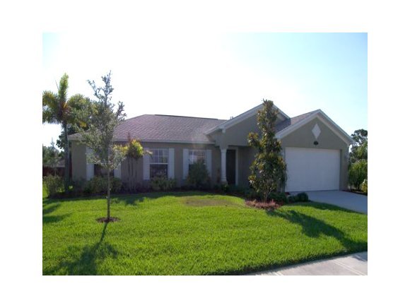 1010 Northeast Morgan Palm Bay, FL 32905 - Photo 1 of 12 a backyard of a house with plants and large tree