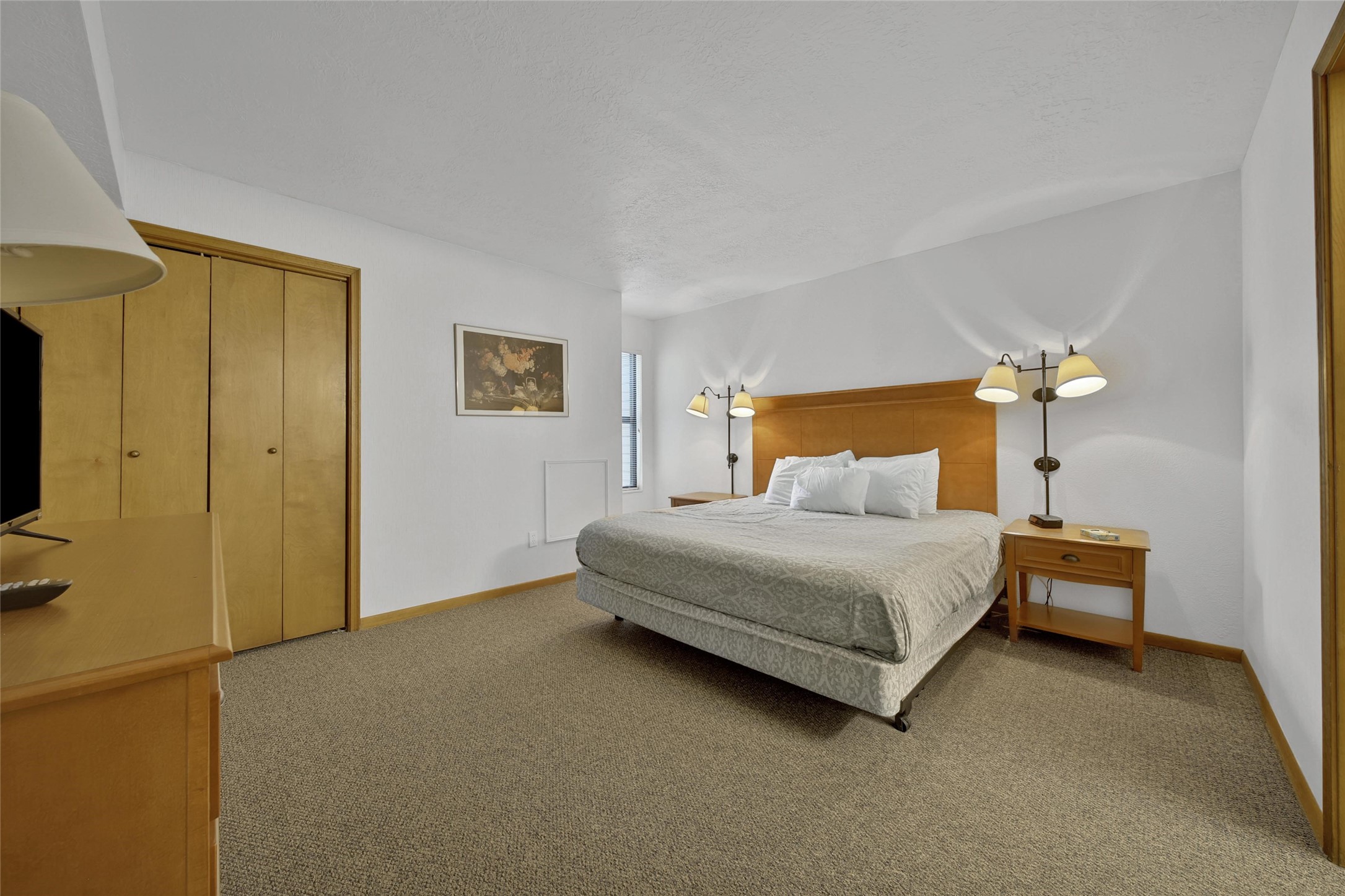1000 April Sound Boulevard Conroe, TX 77356 - Photo 13 of 46 a bedroom with a bed and a chandelier