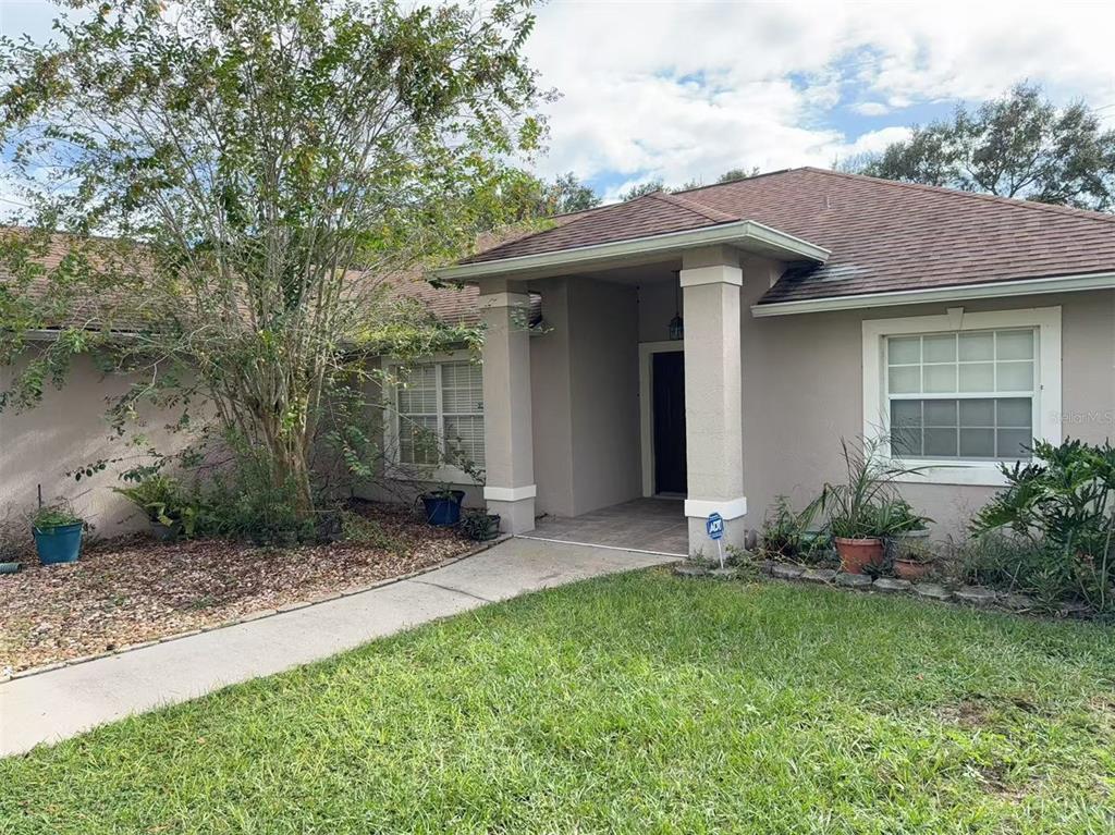 9717 Crenshaw Circle Clermont, FL 34711 - Photo 1 of 11 a view of a house with a yard and plants