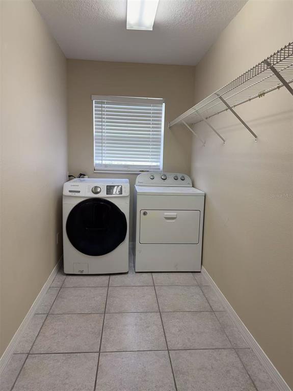 9717 Crenshaw Circle Clermont, FL 34711 - Photo 11 of 11 a utility room with dryer and washer