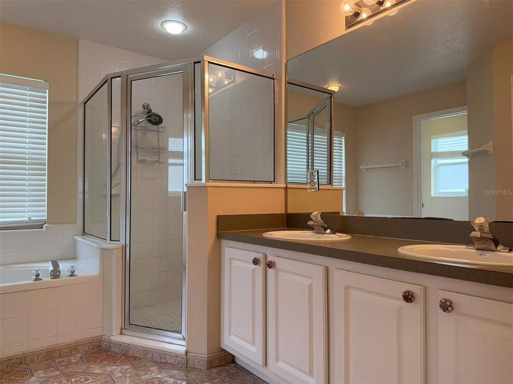 9717 Crenshaw Circle Clermont, FL 34711 - Photo 7 of 11 a bathroom with a granite countertop sink mirror and double