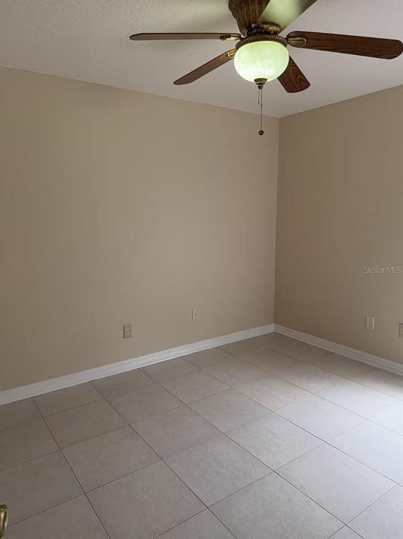 9717 Crenshaw Circle Clermont, FL 34711 - Photo 8 of 11 a view of an empty room with a fan