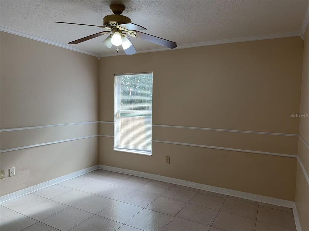 9717 Crenshaw Circle Clermont, FL 34711 - Photo 9 of 11 a view of an empty room with a window