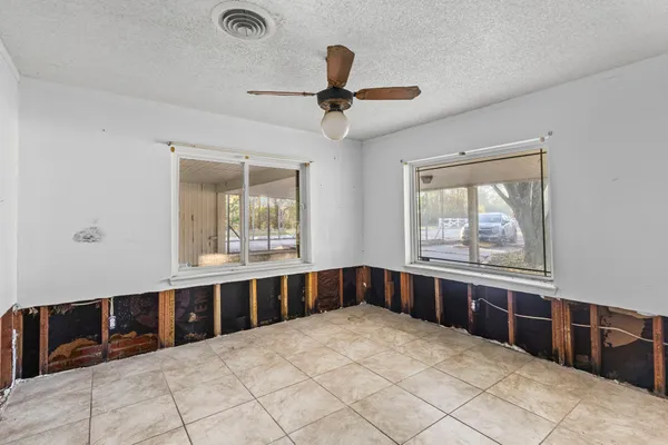 a large white kitchen with a large window