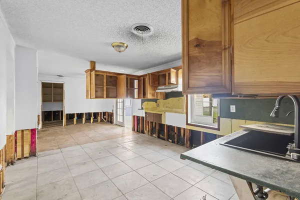 a spacious bedroom with a bed and a cabinets