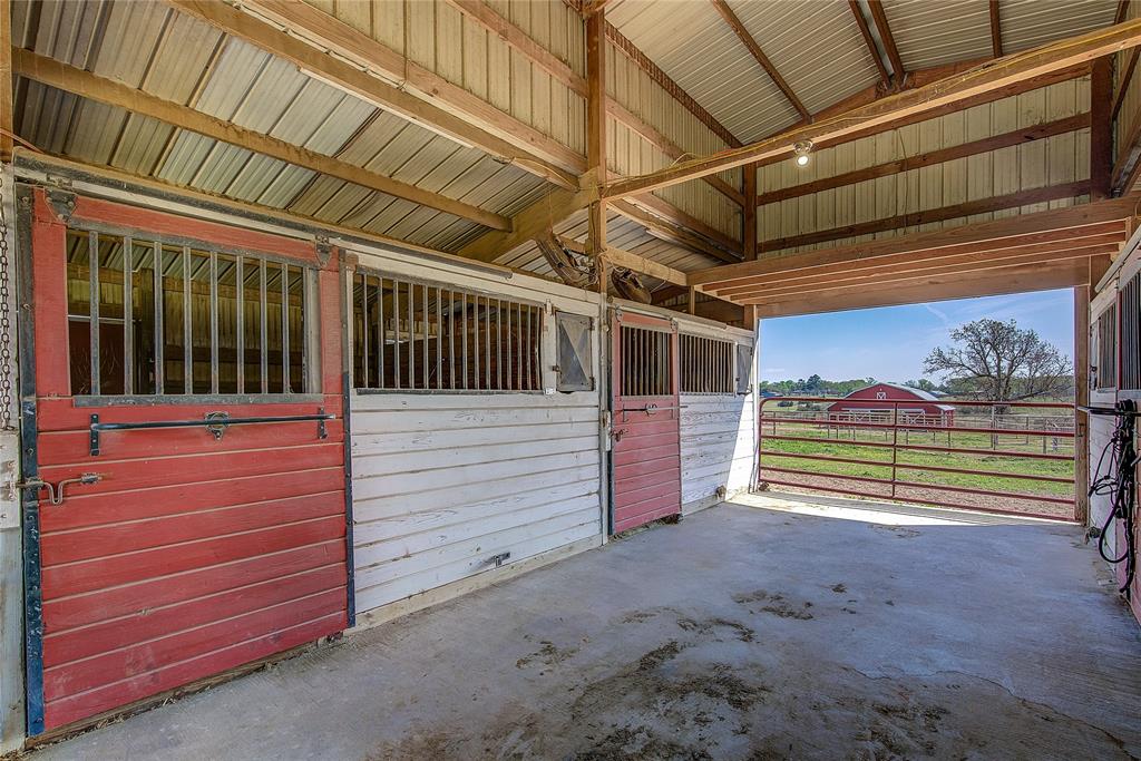 7359 Highway 154 Sulphur Springs, TX 75482 - Photo 35 of 40 This stable has four stalls with bars, hay storage area, tack room, wash bay