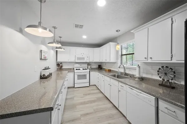 a kitchen with stainless steel appliances granite countertop a sink and cabinets