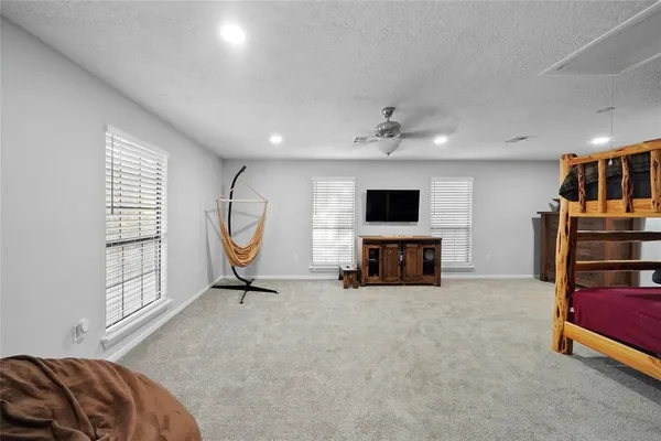 a living room with furniture gym equipment and a flat screen tv