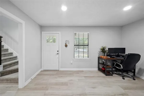 a view of livingroom with workspace and a window