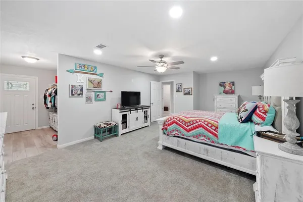 a bedroom with furniture and a flat screen tv