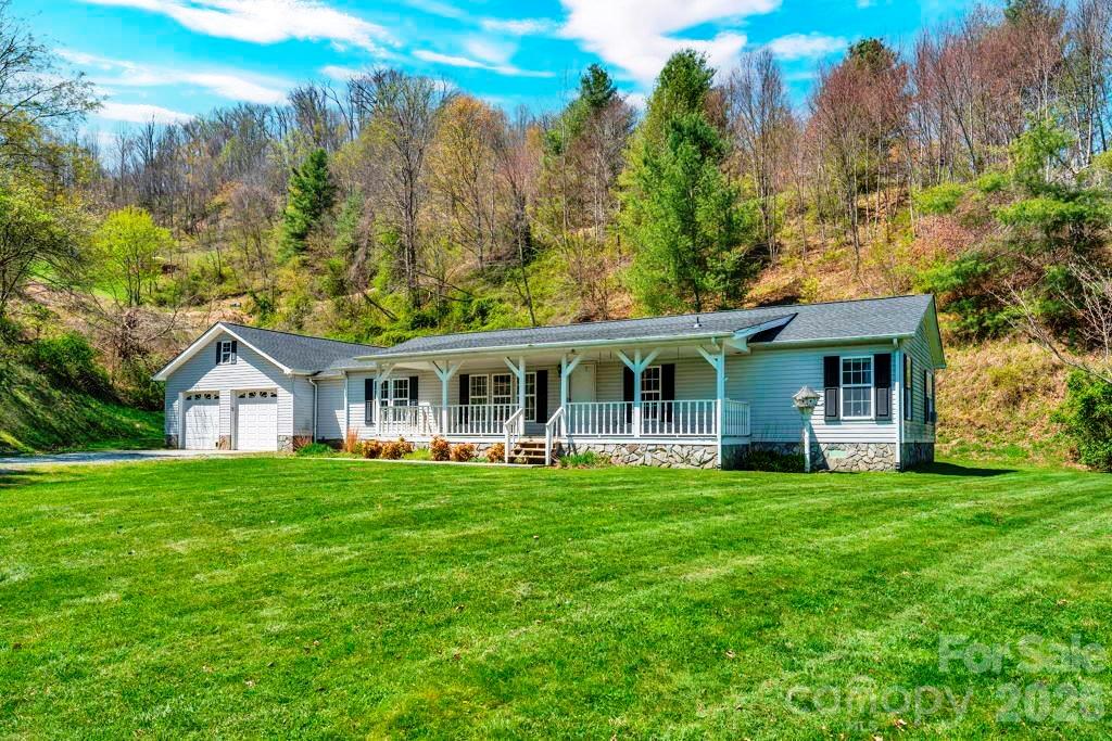 228 Vilas Overlook, Unit 1 Vilas, NC 28692 - Photo 1 of 48 a front view of a house with a garden