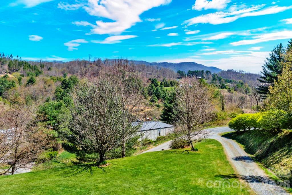 228 Vilas Overlook, Unit 1 Vilas, NC 28692 - Photo 12 of 48 a view of a garden with a building in the background