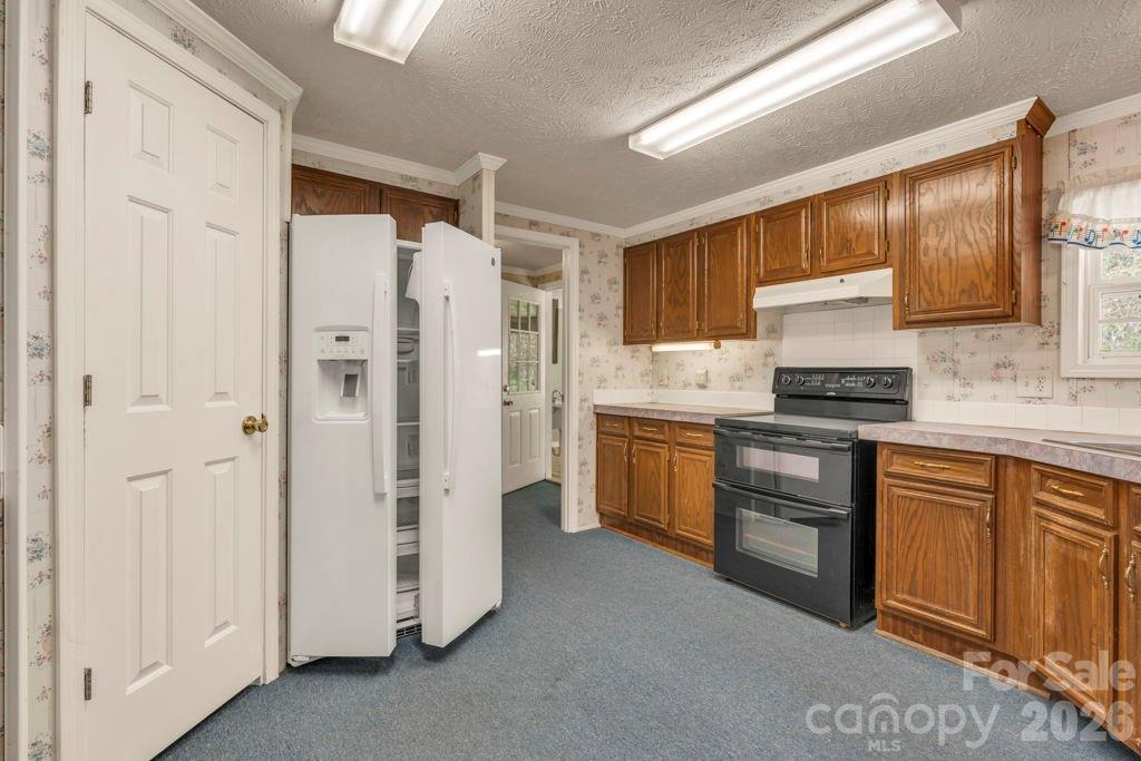 228 Vilas Overlook, Unit 1 Vilas, NC 28692 - Photo 23 of 48 a kitchen with a refrigerator sink and cabinets