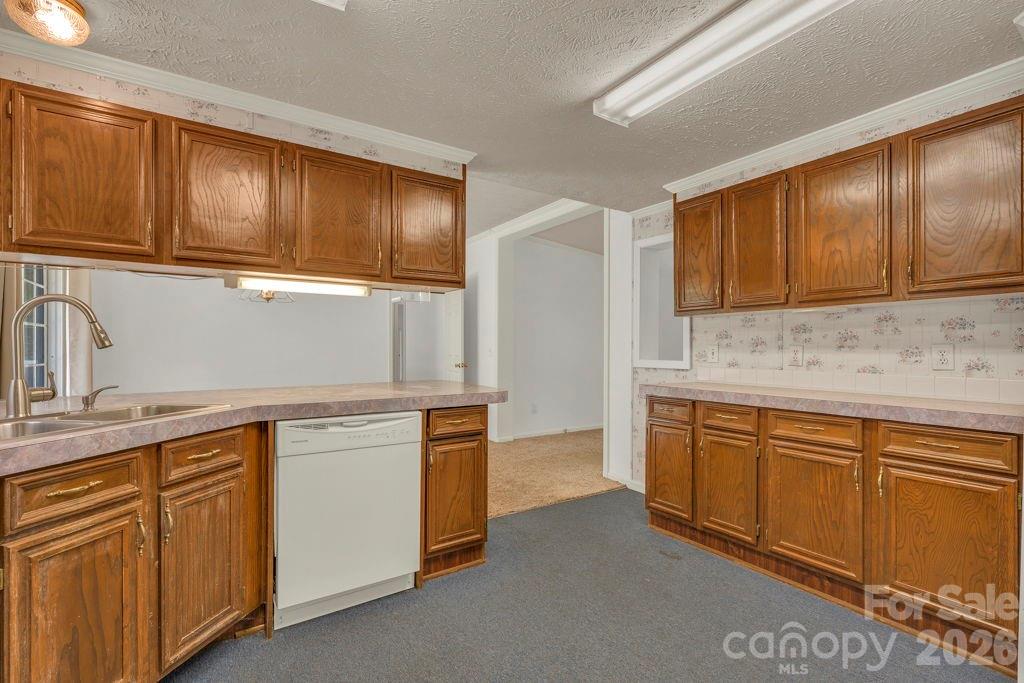228 Vilas Overlook, Unit 1 Vilas, NC 28692 - Photo 24 of 48 a kitchen with stainless steel appliances granite countertop wooden cabinets a sink and dishwasher