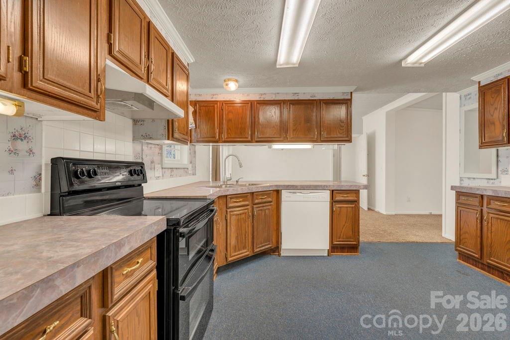 228 Vilas Overlook, Unit 1 Vilas, NC 28692 - Photo 25 of 48 a kitchen with a sink stove and cabinets
