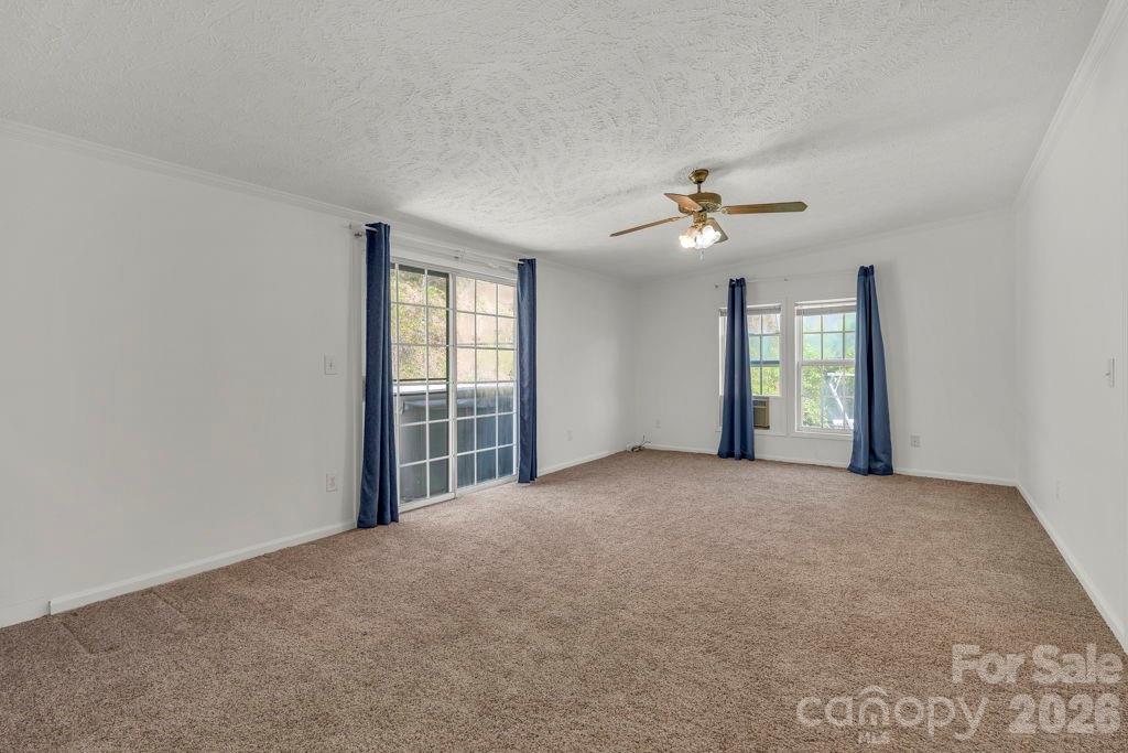 228 Vilas Overlook, Unit 1 Vilas, NC 28692 - Photo 29 of 48 an empty room with windows and ceiling fan