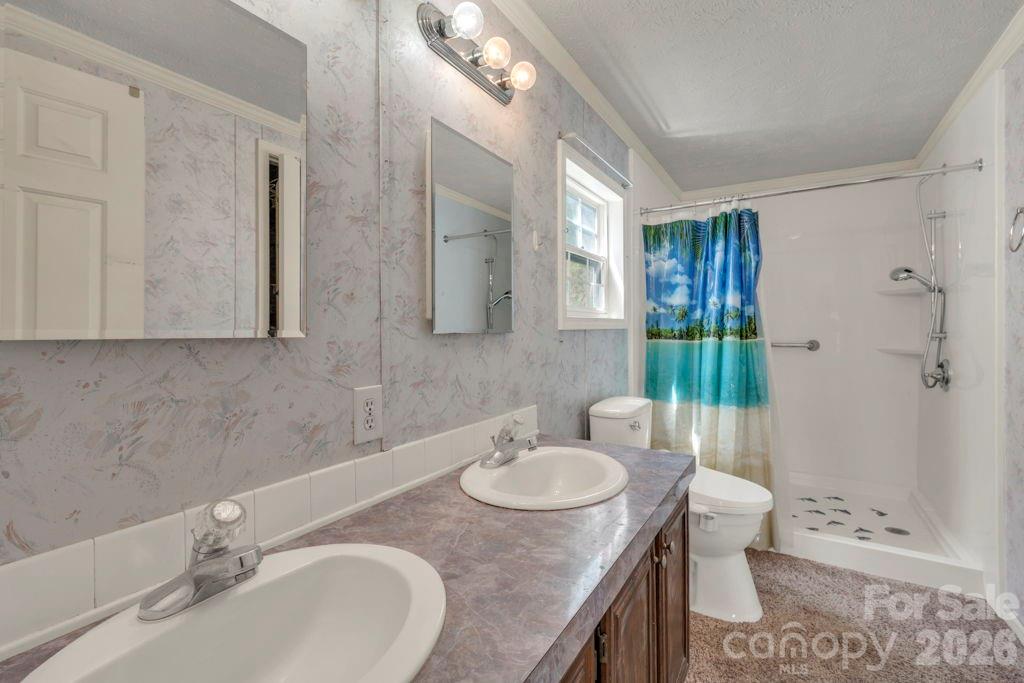 228 Vilas Overlook, Unit 1 Vilas, NC 28692 - Photo 40 of 48 a bathroom with a granite countertop sink toilet and shower