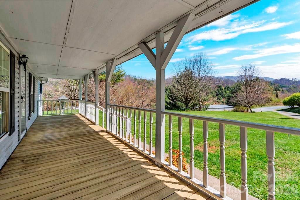 228 Vilas Overlook, Unit 1 Vilas, NC 28692 - Photo 4 of 48 a view of a balcony with wooden floor