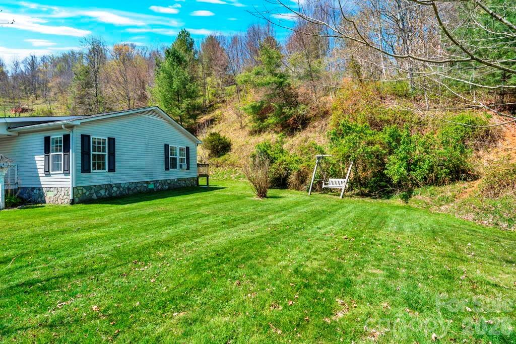 228 Vilas Overlook, Unit 1 Vilas, NC 28692 - Photo 7 of 48 a view of a house with yard and a garden