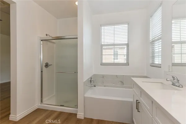 a bathroom with a tub sink and mirror