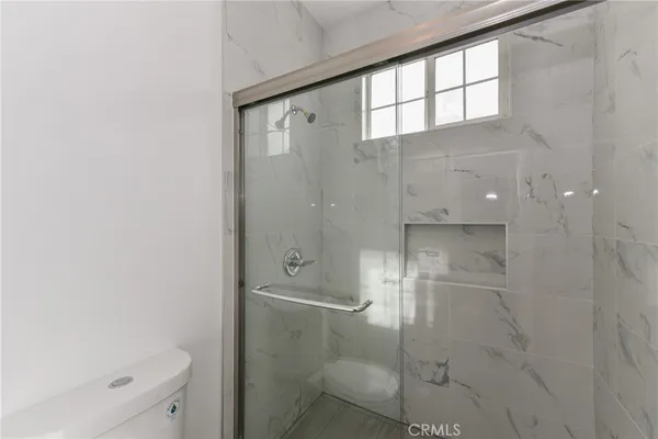 a bathroom with a glass shower door